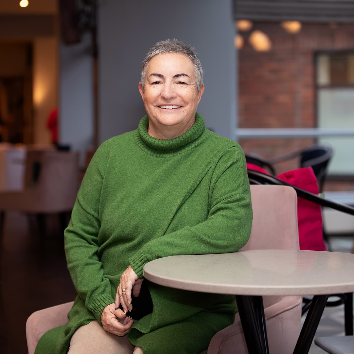 Jane Green Jumper Sitting Down compressed